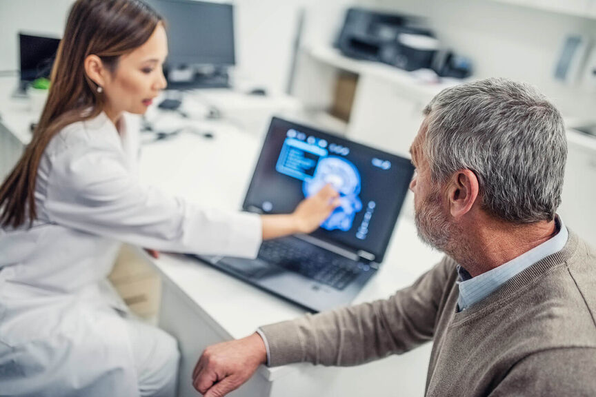 Female-doctor-showing-brain-scan-to-patient