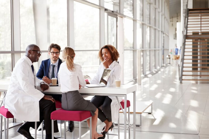 healthcare-administrators-sit-around-a-table