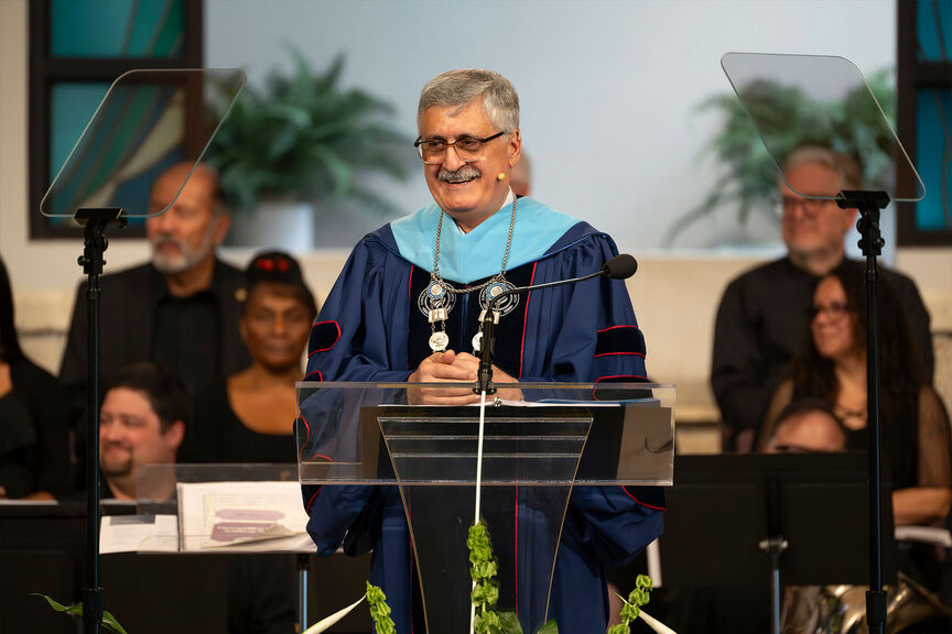 Josef Ghosn in regalia speaking at the lectern during the inauguration ceremony