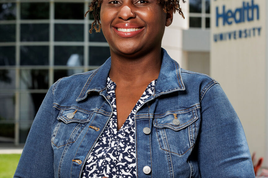 Khandi Stewart-Cooper standing outside the Campus Center building at AHU