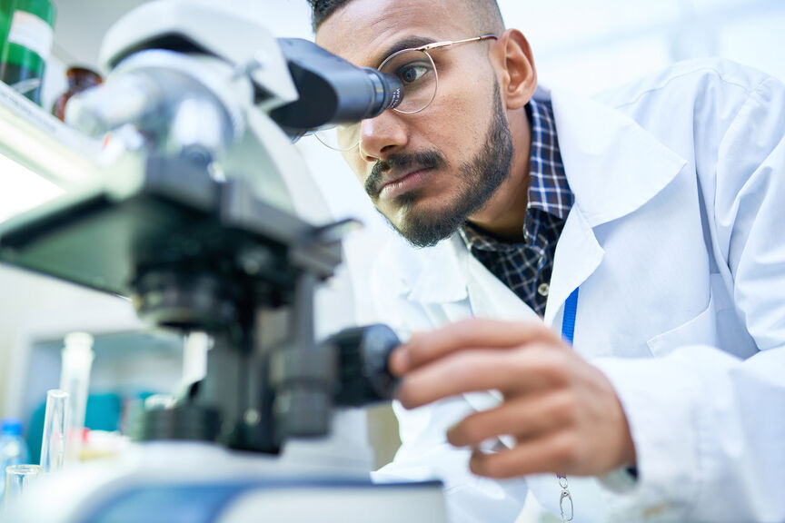Physician using microscope