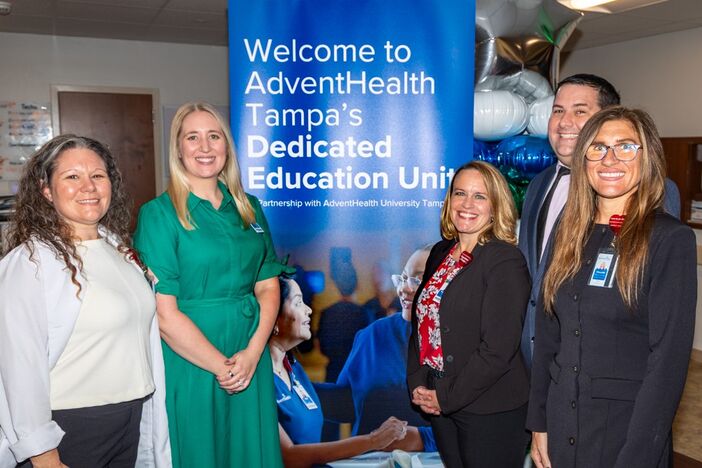 AHU and AdventHealth Tampa leaders in front of the DEU sign