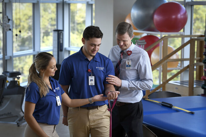 Physical Therapy students using an exercise band