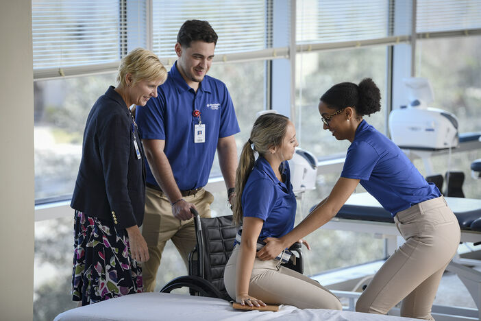 Physical Therapy students and professor demonstrating wheelchair use