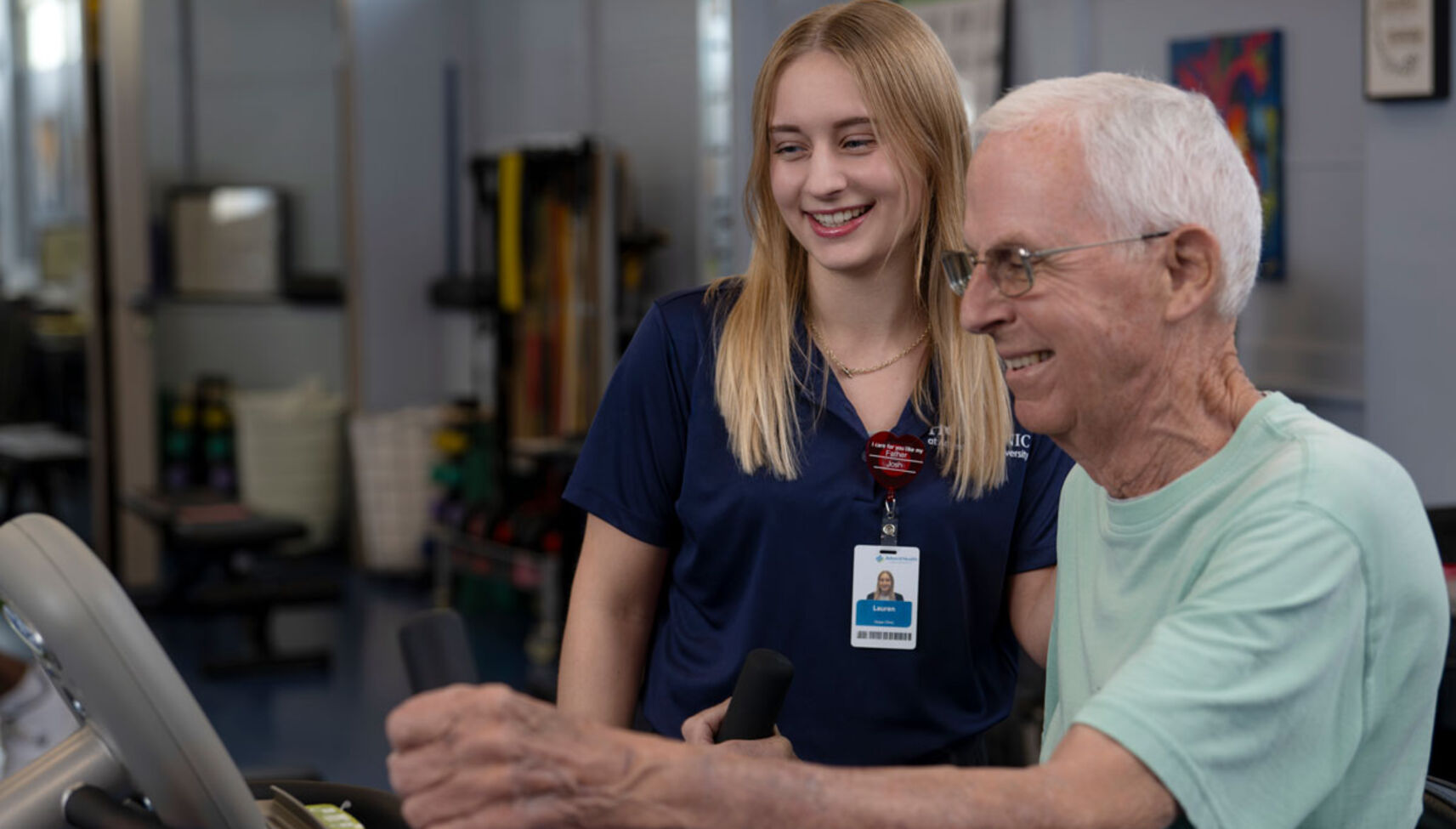 image of occupational therapy assistant student assisting geriatric patient on exercise machine