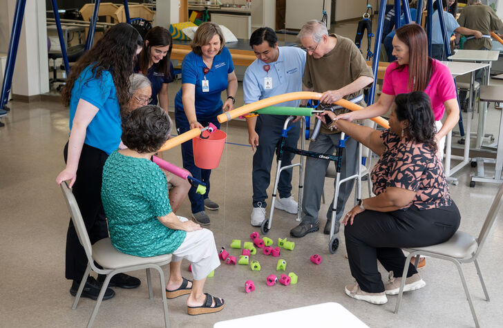 a group of people smiling and working together in the hope clinic.