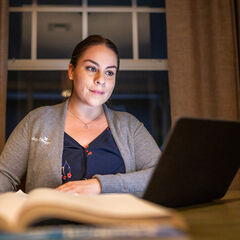 Nurse studying on a laptop