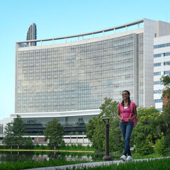 A student walks along the lake at AHU
