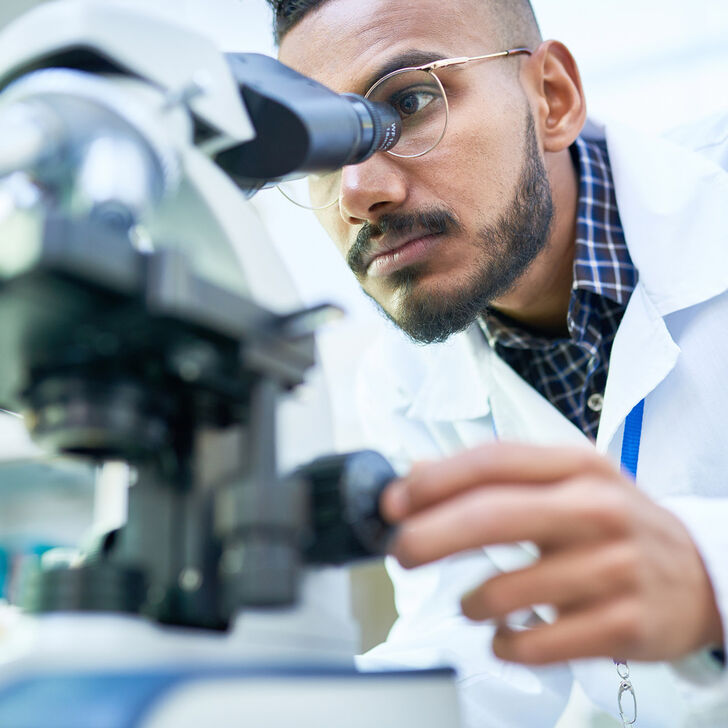 Physician using microscope