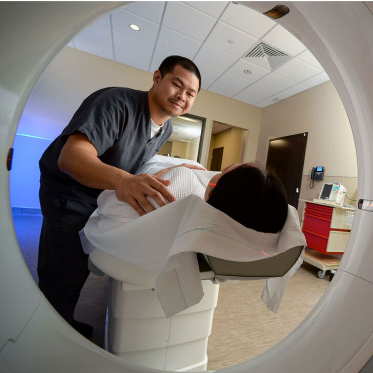 An imaging tech scans a patient