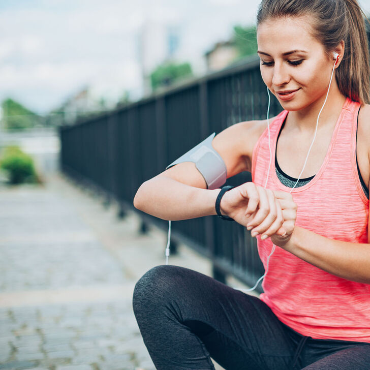 A runner checking her time