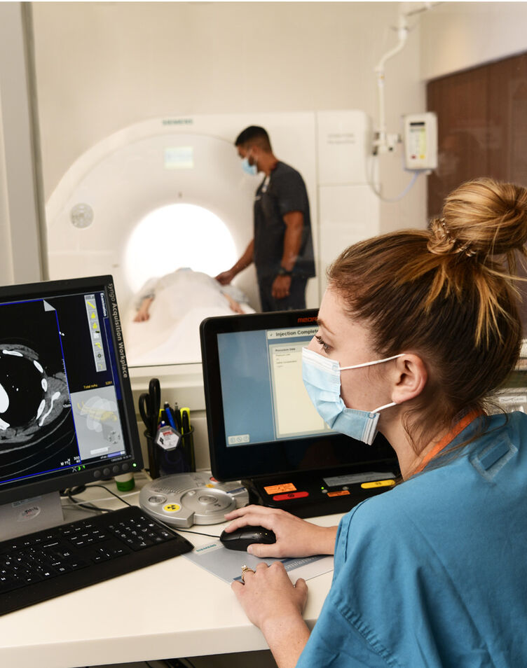 Technicians preform CT scan