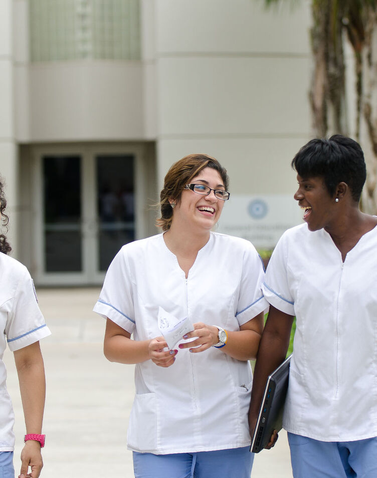 A group of female nursing students in uniform walking outside